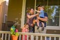 Alumni Kristen Judson and Scott Judson (who’s also current CAAA president-elect) blow bubbles on their porch to the delight of their two small children.