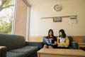 Afternoon sun pours into the lounge where undergraduate students Ruyi Ke, economics, and Fanyang Chu, genetics and genomics, enjoy companionship and Internet curiosities.