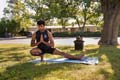 Victor Reyes Jr., senior, biological sciences major, practices yoga in the park.