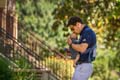 Kevin Blue, athletics director, kisses the forehead of his baby daughter.