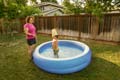 Elina L. Niño, Assistant specialist in Cooperative Extension, Department of Entomology and Nematology, looks on as her son beats the heat in a backyard wading pool.